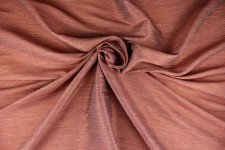 This multi-purpose mock linen in poppy red with gold tones has a classic raw silk look and is suitable for draperies, curtains, cornice boards and headboards.  We offer this fabric in other colors.