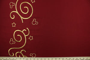 Mittens is a solid red fabric featuring an embossed, embroidered design of a gold scroll, stars and mouse ears.  Uses include light upholstery, pillows, bedding and window treatments.  