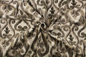  This fabric features a demask design in black, taupe, pale gray, and dull white. 