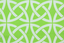 Load image into Gallery viewer, Nordic is a large geometric print with interlocking shapes in lime green and white.  It is perfect for outdoor settings or indoors in a sunny room.  It is stain and water resistant and can withstand up to 700 hours of direct sun exposure.  Uses include decorative pillows, cushions, chair pads, tote bags and upholstery. 
