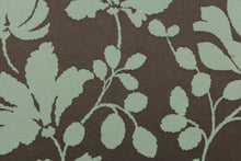 Load image into Gallery viewer, This fabric features a large-scale floral pattern in light olive green on a rich brown background.  The slight sheen enhances the design.  It would be great for home decor such as multi-purpose upholstery, window treatments, pillows, duvet covers, tote bags and more.  It has a soft workable feel yet is stable and durable.
