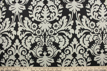 Load image into Gallery viewer, This fabric features a large damask pattern in light gray against a solid black background.  It will stand up to abrasion and tension to bring long lasting beauty to your home.  Uses include drapery, headboards, bedding, accent pillows, cushions, slip covers and upholstery.

