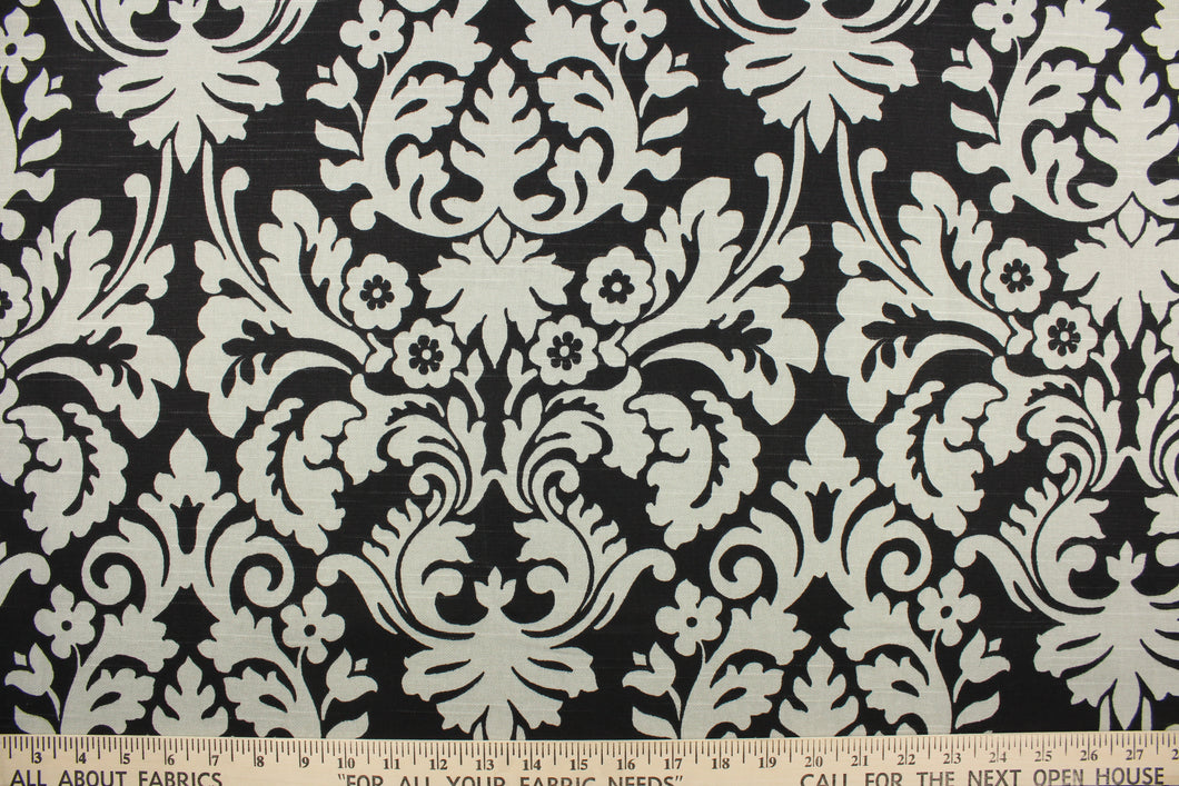 This fabric features a large damask pattern in light gray against a solid black background.  It will stand up to abrasion and tension to bring long lasting beauty to your home.  Uses include drapery, headboards, bedding, accent pillows, cushions, slip covers and upholstery.