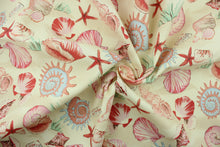 Load image into Gallery viewer, Sea shells is a multi use fabric that features large assorted shells in shades of powder blue, pink, mauve, dusty rose, apricot, brick red and brown on a cream background.  It is perfect for outdoor settings or indoors in a sunny room.  It is stain and water resistant and can withstand up to 700 hours of direct sun exposure.  Uses include decorative pillows, cushions, chair pads, tote bags and upholstery.  We offer this pattern in several colors.
