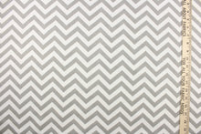 Load image into Gallery viewer, This printed flannel features a chevron pattern in grey and white.  Uses include apparel, bedding, pillows, home decor and crafting.  This fabric has a soft workable feel. 
