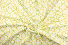 Load image into Gallery viewer, This printed cotton twill fabric features a geometric design in yellow and green on a white background.  It is perfect for window treatments, decorative pillows, handbags, light duty upholstery applications.  This fabric has a soft workable feel yet is stable and durable with 50,000 double rubs.  
