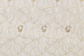 This lace features a woven floral design in white with a gold outline. 