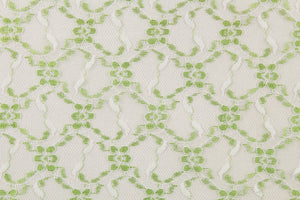 This lace features a woven floral design in green and white . 