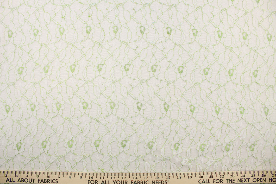 This lace features a woven floral design in white with green outline.