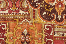Load image into Gallery viewer, This ethnic patchwork design is printed on linen and viscose and contains the colors of orange, spice red, tan, gold and raisin.  It is perfect for window treatments, decorative pillows, handbags, light duty upholstery applications.  This fabric has a soft workable feel yet is stable and durable with 12,000 double rubs.  
