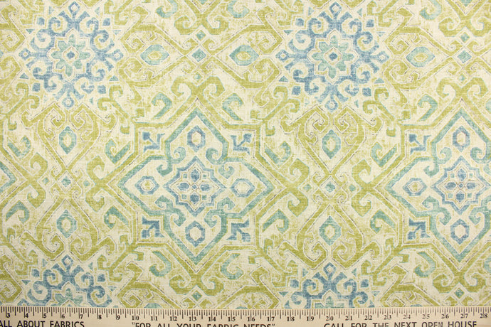 This multi purpose fabric features a geometric medallion print in green and blue on a cream background. It is perfect for window treatments, decorative pillows, handbags, light duty upholstery applications.  This fabric has a soft workable feel yet is stable and durable with 12,000 double rubs.  