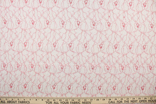 This lace features a woven floral design in white with red outline. 