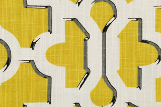 This fabric features a geometric design in mustard yellow outlined in gray and black against a white background.