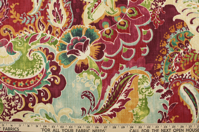 This fabric features a paisley design in teal, burgundy, golden yellow, green, blue and off white  .