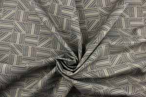 This high end upholstery weight fabric features a geometric design in blue and beige on a metal gray background.  It is suited for uses that requires a more durable fabric.  The reinforced backing makes it great for upholstery projects including sofas, chairs, dining chairs, pillows, handbags and craft projects.  It is soft and pliable and would make a great accent to any room. 