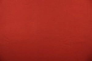  A mock linen in a rich red with a latex backing . 