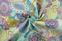 Load image into Gallery viewer, Flower Child is a large medallion flower print that is perfect for outdoor settings or indoors in a sunny room.  This multi use fabric features a water and stain resistant finish.  Uses include decorative pillows, cushions, chair pads, tote bags and upholstery.  Colors included are purple, apricot, turquoise, light blue, yellow, gold and white.
