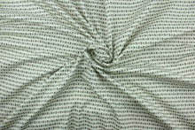 Load image into Gallery viewer,  Fairmont features a modern ogee design screen printed on a cotton twill base in the colors of brown, tan and white with hints of mint green and features a soil and stain repellant finish.   The multi use fabric is perfect for window treatments, decorative pillows, custom cushions, bedding, light duty upholstery applications and almost any craft project.  It has a soft workable feel yet is stable and durable with 50,000 double rubs.
