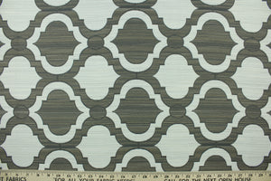 This fabric features a geometric design in gray, tan and off white . 
