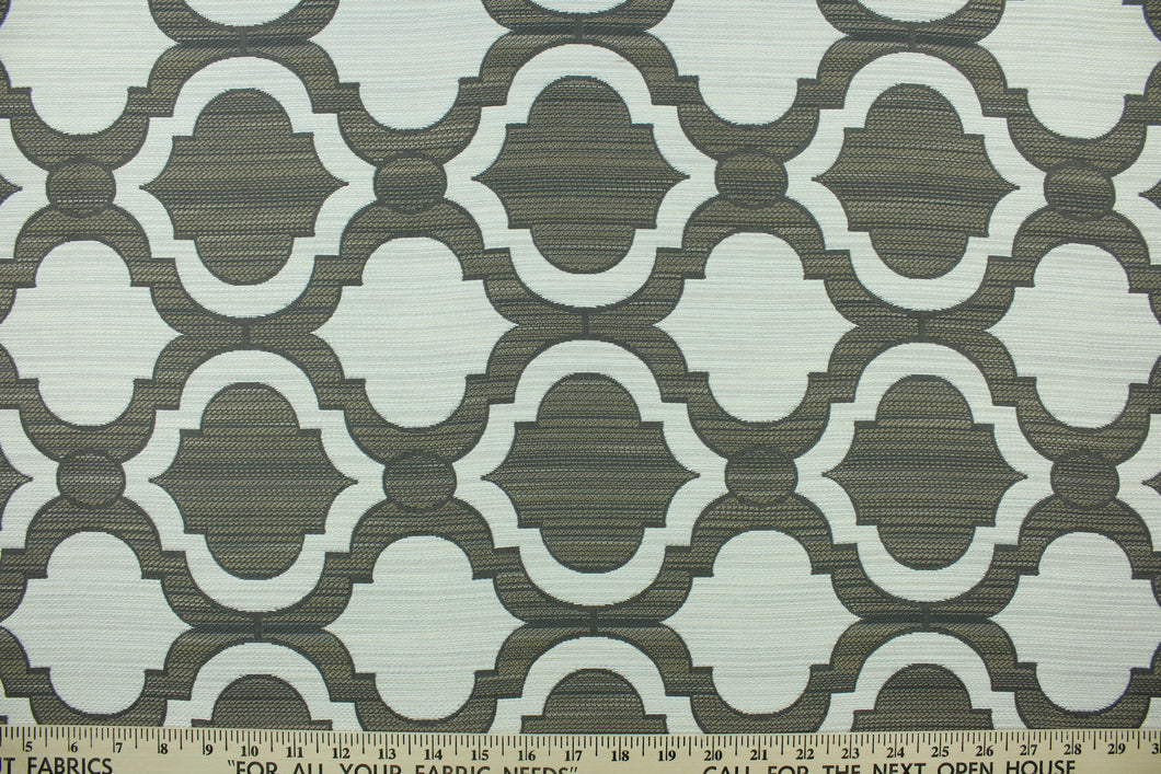 This fabric features a geometric design in gray, tan and off white . 