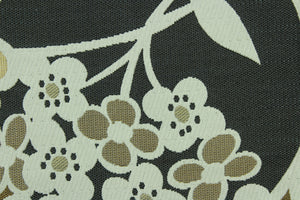This fabric features a floral design in gold, dark gray, tan and pale beige with a latex backing.