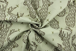This fabric features a Elk head design in brown and olive green set against a beige background with a latex backing. 