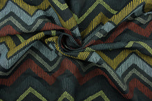 Load image into Gallery viewer, This fabric features a chevron design in pale blue, golden yellow, brick red, taupe, dark gray, and green set against a dull black background . 

