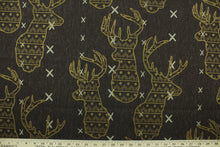 Load image into Gallery viewer, This fabric features a Elk head design in golden tan and beige set against a brown background with a latex backing. 
