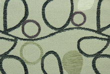 Load image into Gallery viewer, This fabric features a unique design in gray, black, beige, purple, taupe, and cream set against a beige background with a latex backing.
