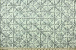  This fabric features a geometric design in gray, and off white.