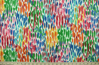 This outdoor fabric features a colorful design in green, blue, pink, yellow, orange, turquoise, and red set against a white background . 