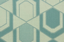 Load image into Gallery viewer,  This fabric features a geometric design in gray turquoise and pale beige .
