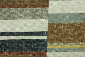 This fabric features a geometric design in golden tan, gray, dull black, tan, copper, brown, natural, seafoam green.