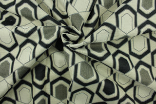 This fabric features a geometric design in black, gray, and beige . 