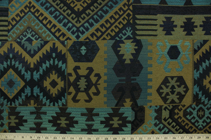 This fabric features an Aztec design in dark brown, tan, black and teal with hints of blue. 