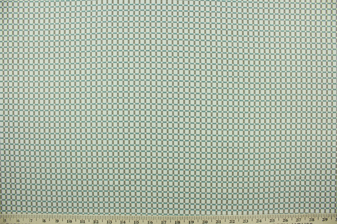  This fabric features a checkered design in gray, off white and light turquoise blue with a latex backing.