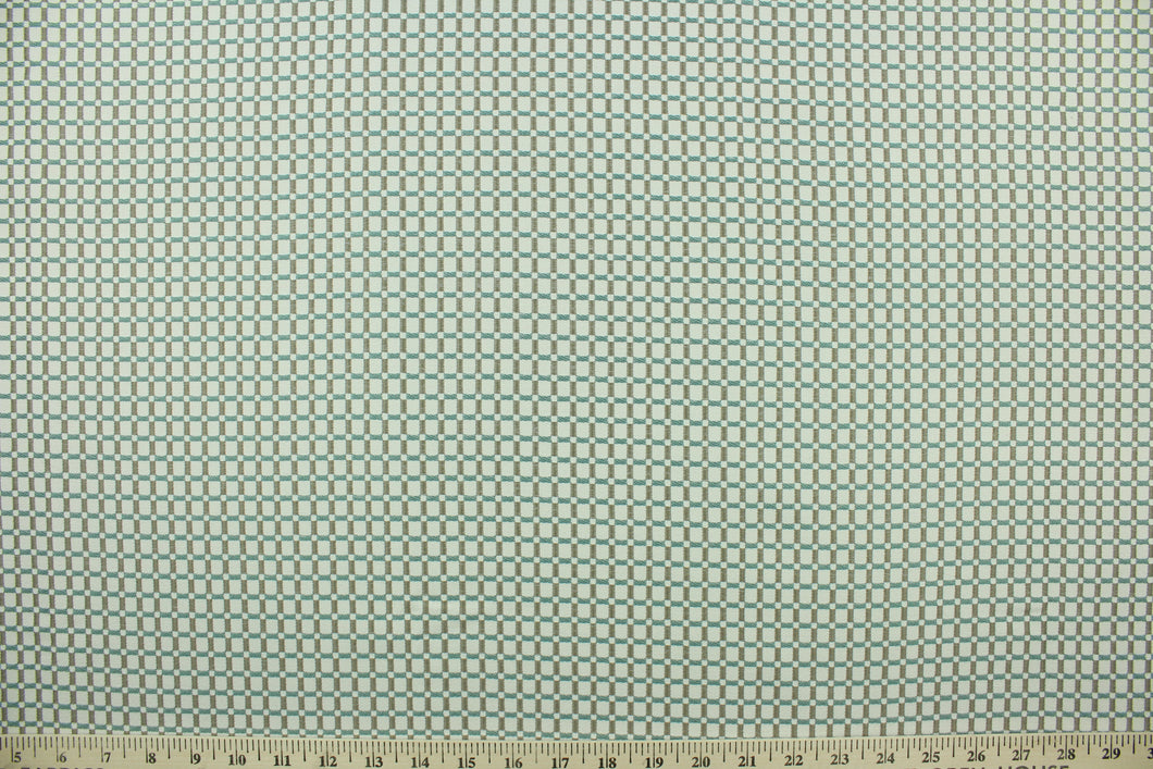  This fabric features a checkered design in gray, off white and light turquoise blue with a latex backing.