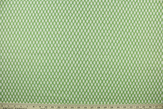 This fabric features a diamond design in green and white with hints of golden yellow. 