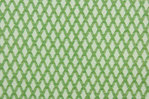 This fabric features a diamond design in green and white with hints of golden yellow. 