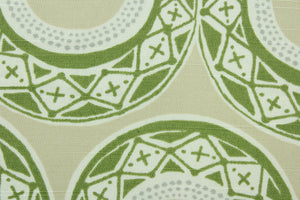 This fabric features a serpentine design in green, gray, white and beige . 