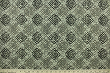 Load image into Gallery viewer,  This fabric features a geometric design in  gray, black, taupe and beige with a latex backing.
