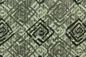 This fabric features a geometric design in  gray, black, taupe and beige with a latex backing.
