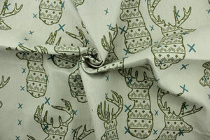 This fabric features a Elk head design in green and turquoise set against a beige background with a latex backing. 