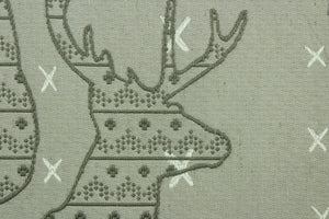 This fabric features a Elk head design in gray and cream set against a beige background with a latex backing.