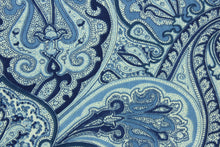 Load image into Gallery viewer, This fabric features a paisley design in shades of blue and cream .
