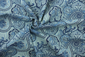 This fabric features a paisley design in shades of blue and cream .