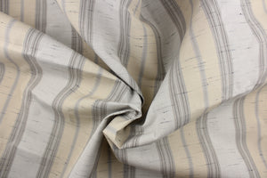  This  fabric features a stripe design  in gray, white, light khaki, and black. 