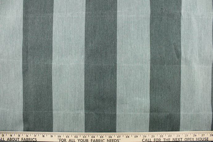  This fabric features a wide stripe design in a dark and light washout green.