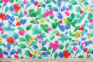 This fabric features a floral design in green, red, blue, turquoise, yellow, and  hot pink against a white background. 