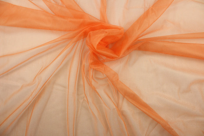 A sheer, light weight, and semi firm tricot in orange.